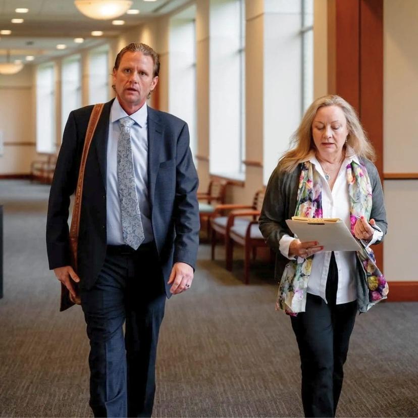 Image of Andrew Davis walking with client